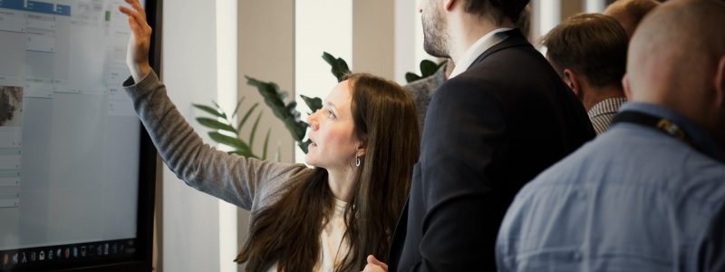 Woman presenting DigiLEAN for customer on a touch screen